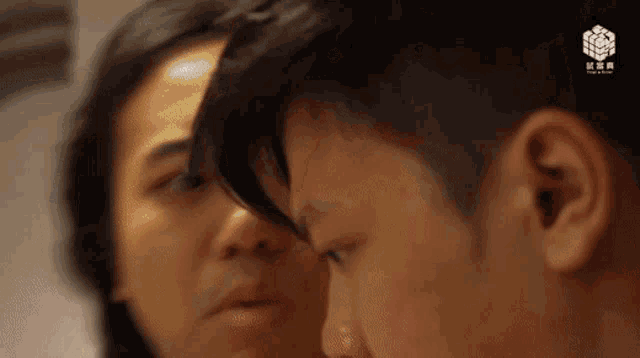 a man and a woman are looking at each other in a room .