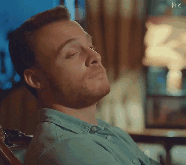 a man sitting in a chair with his eyes closed