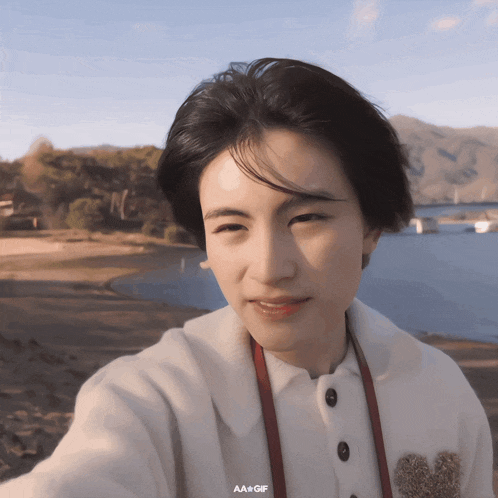 a girl taking a picture of herself with the words aa + gif above her