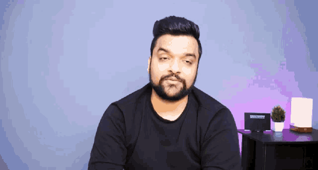 a man in a black shirt is looking down