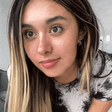 a close up of a woman 's face with her eyes looking at the camera