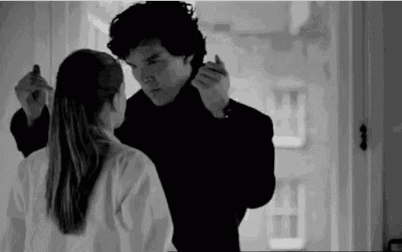 a man and a woman are standing next to each other in a room .