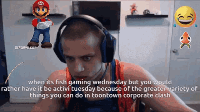 a man wearing headphones is playing a video game with a mario character behind him