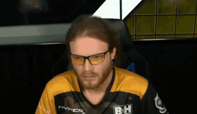 a man wearing glasses and a shirt that says hyper on it