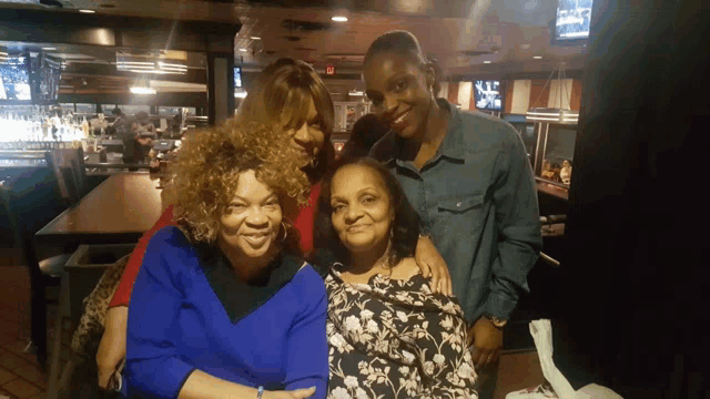 a group of people posing for a picture in a bar