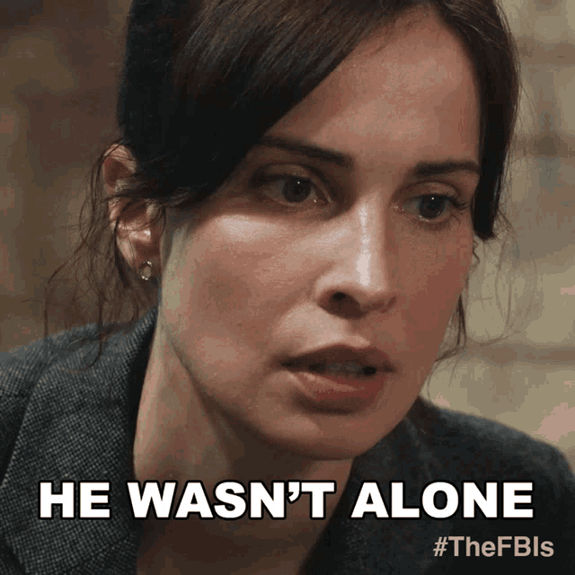 a close up of a woman 's face with the words he wasn 't alone