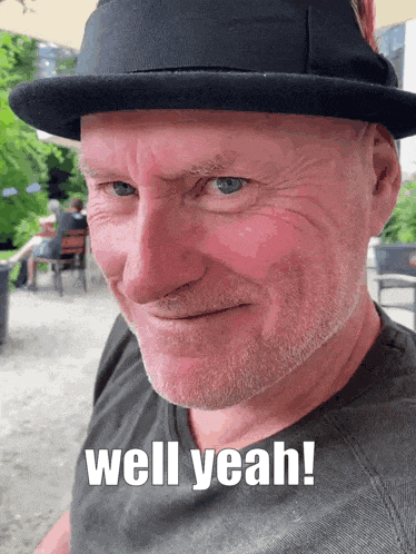a man wearing a hat with the words well yeah written on his face
