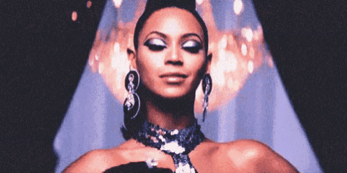 a close up of a woman wearing a necklace and earrings