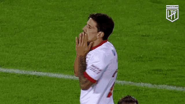 a soccer player wearing a white banco city jersey