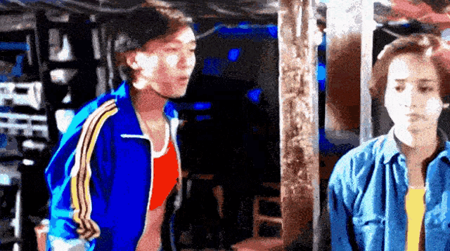 a man in a blue jacket is standing next to a woman
