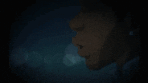a close up of a person 's face in the dark