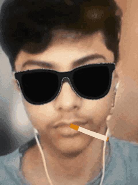 a man wearing sunglasses is smoking a cigarette in his mouth