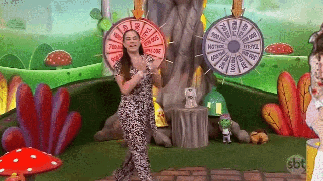 a woman is standing in front of a spinning wheel that says sbt