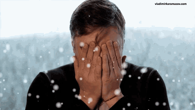 a man covering his face with his hands and the website vladimirkaramazov.com is visible