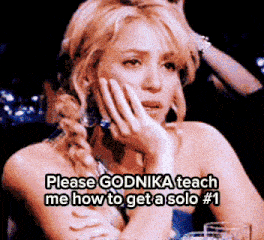 a woman sitting at a table with a caption that says please godnika teach me how to get a solo # 1 on it