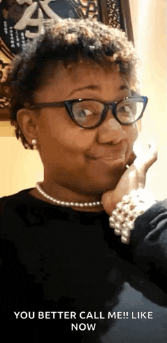 a woman wearing glasses and a pearl necklace says " you better call me ! like now "