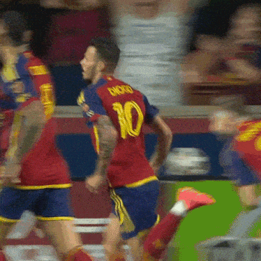 soccer player wearing a red jersey with the number 10 on it