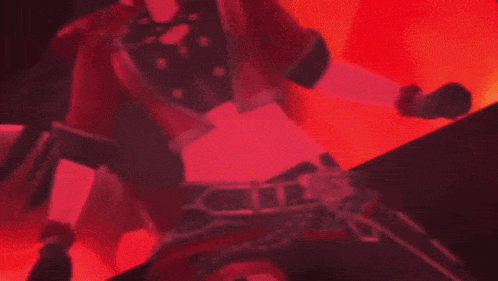 a girl in a red and black outfit is dancing in a dark room