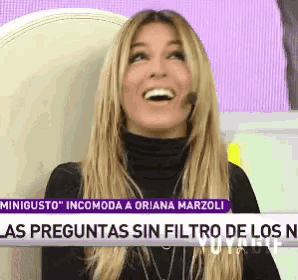 a woman is sitting in front of a sign that says minigusto incomoda a oriana marzoli