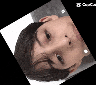 a close up of a person 's face with a capcut icon in the corner
