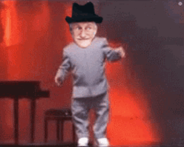 a man in a hat is dancing on a stage in front of a piano .