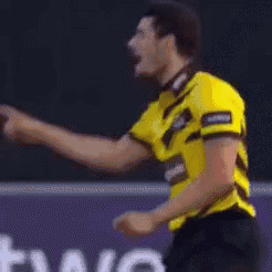 a man wearing a yellow shirt that says brightest