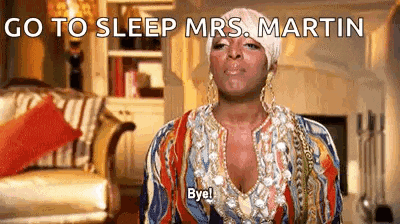 a woman in a colorful dress is sitting in a living room and says `` go to sleep mrs. martin '' .