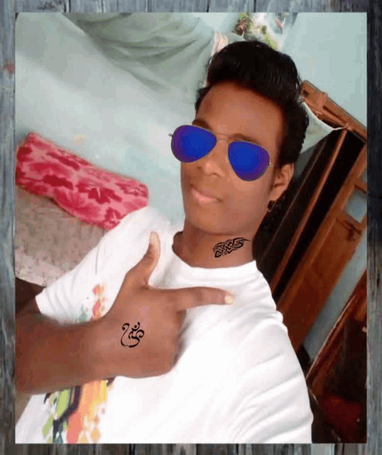 a man wearing sunglasses and a tattoo on his neck