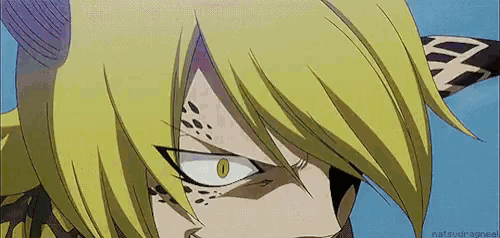 a close up of a person 's face with yellow hair and horns .