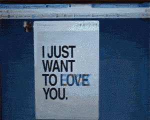 a computer screen displays a sign that says i just want to love you
