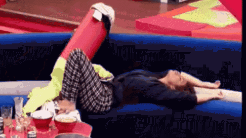 a woman laying on a couch with her legs up