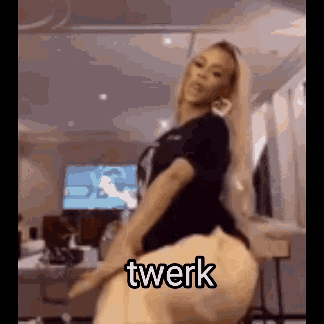 a woman is dancing in a living room with the word twerk written on the bottom of the image .
