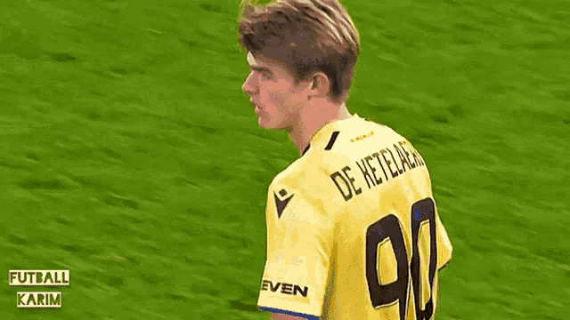 a young man wearing a yellow jersey with the number 92 on the back
