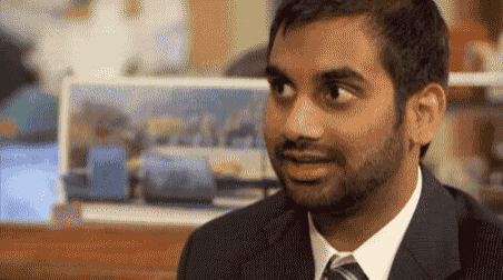 a man with a beard wearing a suit and tie is smiling