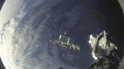 a view of the earth from space shows a space station in the distance