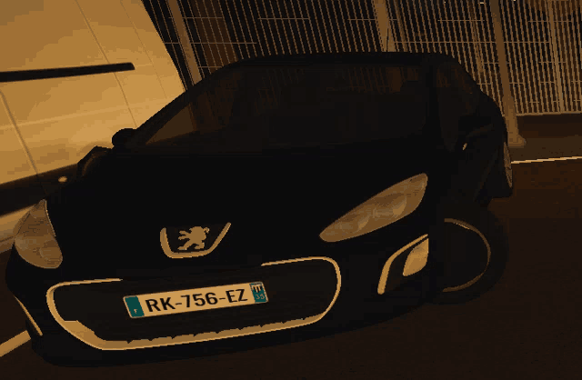 a black peugeot car has a license plate that says rk-756-ez