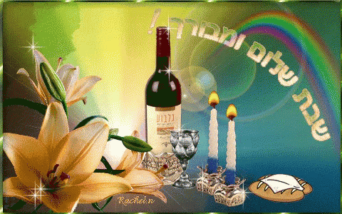 a bottle of wine sits in front of a rainbow and candles