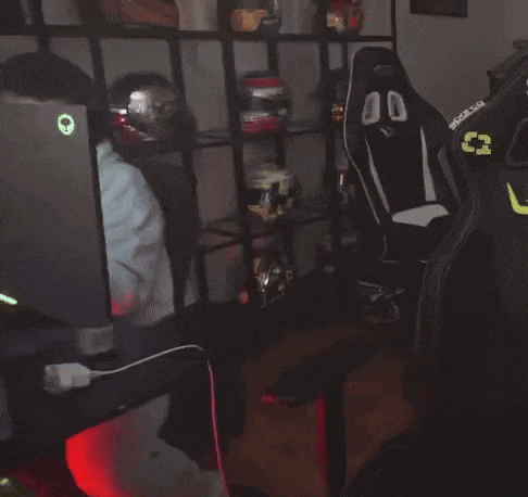 a man wearing headphones is sitting in front of a computer and a chair that says eparco