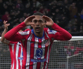 a soccer player wearing a red and white striped jersey that says riyadh on it