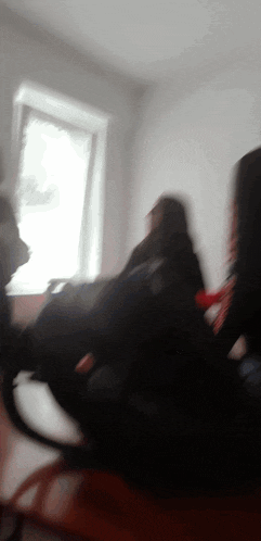 a blurry picture of a person sitting in a room