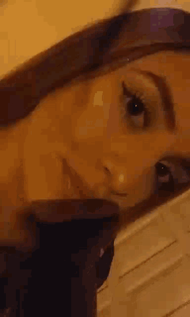 a close up of a woman 's face with her eyes closed and her mouth open .