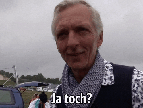 a man wearing a scarf says ja toch in a foreign language