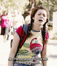 a girl with pigtails is wearing a flamingo shirt and says no i 'm not dramatic