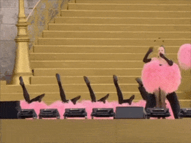 a group of people are standing on a stage with pink pom poms on their heads .