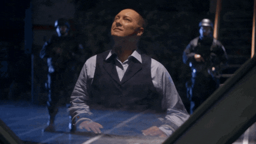 a man in a suit stands in front of a screen that says so let 's say for the moment our interest