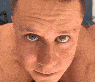 a close up of a man 's face with his eyes closed