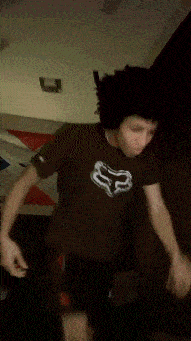 a man wearing a brown shirt with a white fox on it