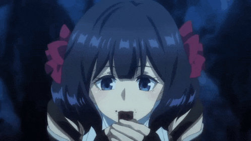 a girl with blue hair and red ribbons in her hair is eating a piece of chocolate