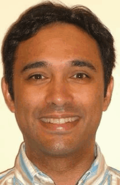 a close up of a man 's face smiling .