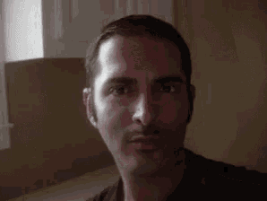 a close up of a man 's face with a beard